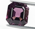 3.95 ct natural purple spinel emerald step cut held in tweezers, close-up face-up view showing deep purple color and step facets
