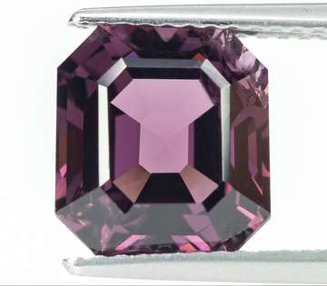 3.95 ct natural purple spinel emerald step cut loose gemstone held in tweezers, face-up view