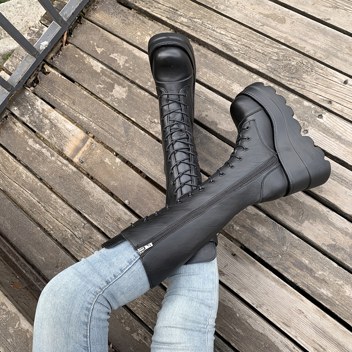 Black knee high platform boots darkwave fashion women close up lace up front and PU leather upper