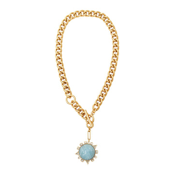 Gold chain necklace with a blue gemstone pendant on a white background