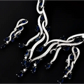 Silver necklace with blue gemstones on a black background