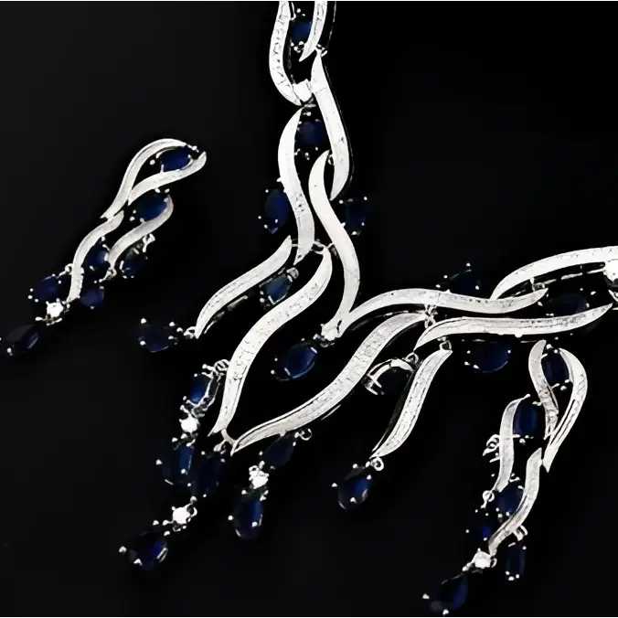 Silver necklace with blue gemstones on a black background
