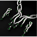 Silver necklace with green gemstones on a black background