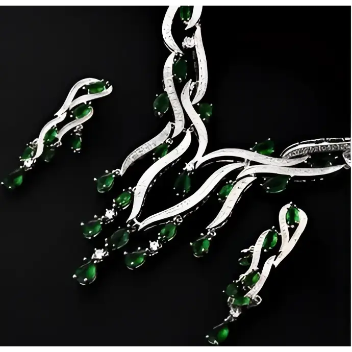 Silver necklace with green gemstones on a black background